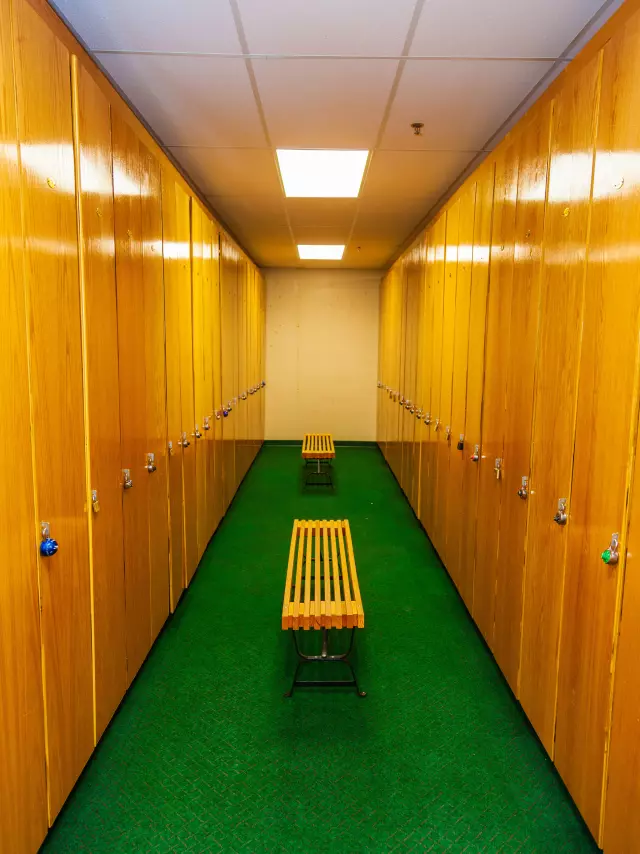 A bench in the middle of a locker room.